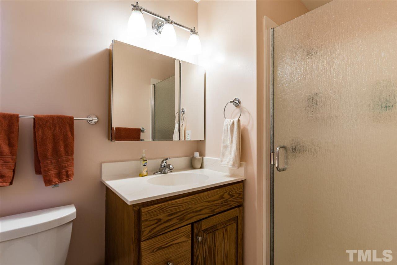 2603 Cottage Circle Raleigh, NC 27613 - Photo 19 of 25 a bathroom with a sink and a mirror