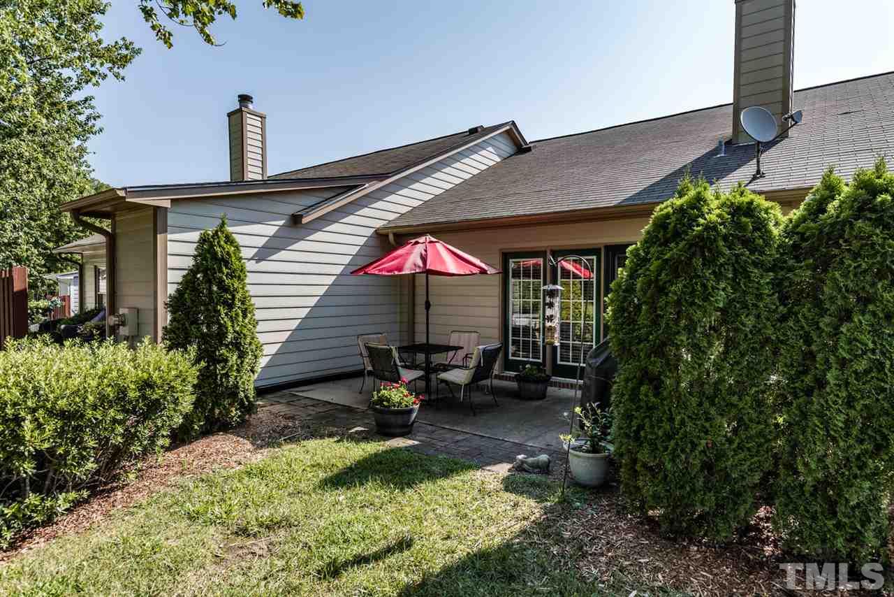 2603 Cottage Circle Raleigh, NC 27613 - Photo 5 of 25 a view of backyard with a table and chair under an umbrella