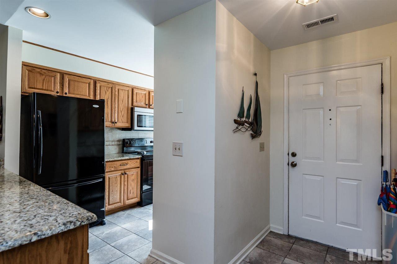 2603 Cottage Circle Raleigh, NC 27613 - Photo 6 of 25 a kitchen with stainless steel appliances granite countertop a refrigerator and a sink