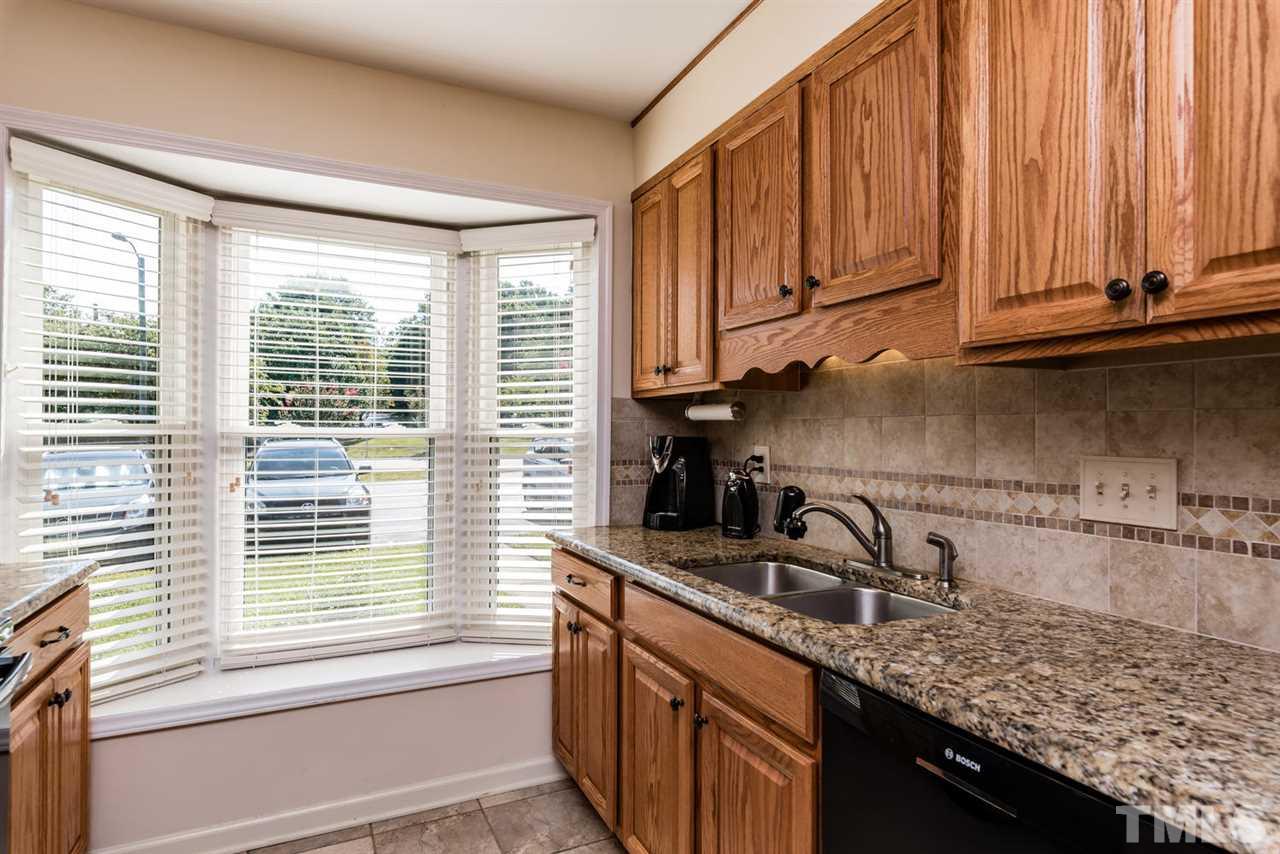 2603 Cottage Circle Raleigh, NC 27613 - Photo 8 of 25 a kitchen with stainless steel appliances granite countertop a sink a stove and a microwave