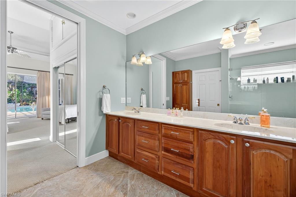 2229 Goshawk Court Naples, FL 34105 - Photo 12 of 29 a spacious bathroom with a granite countertop sink mirror and double