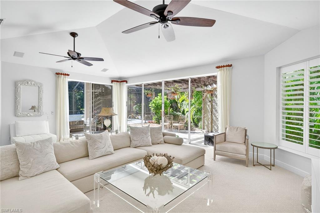2229 Goshawk Court Naples, FL 34105 - Photo 2 of 29 a living room with furniture and a large window