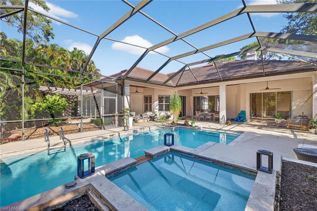 2229 Goshawk Court Naples, FL 34105 - Photo 21 of 29 a view of a backyard with swimming pool