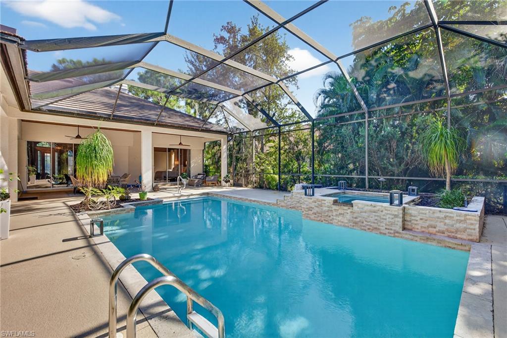 2229 Goshawk Court Naples, FL 34105 - Photo 23 of 29 a view of a swimming pool with a patio