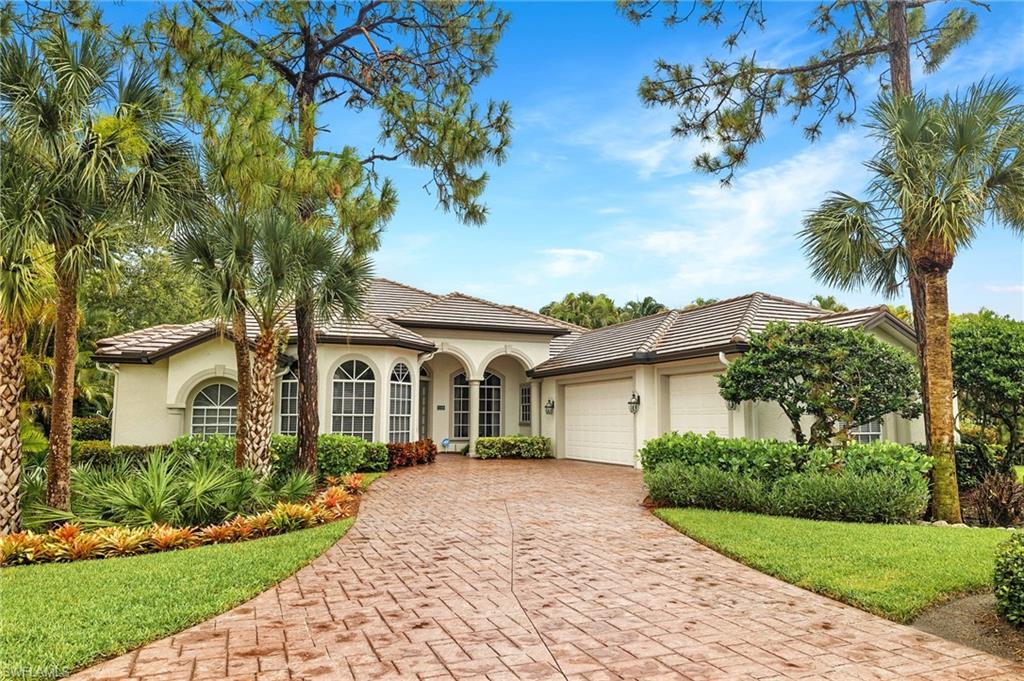 2229 Goshawk Court Naples, FL 34105 - Photo 29 of 29 front view of a house with a garden