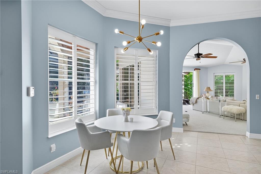 2229 Goshawk Court Naples, FL 34105 - Photo 4 of 29 a view of a dining room with furniture window and wooden floor