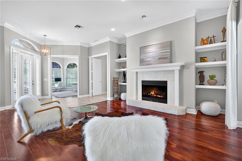 2229 Goshawk Court Naples, FL 34105 - Photo 8 of 29 a living room with furniture and a fireplace