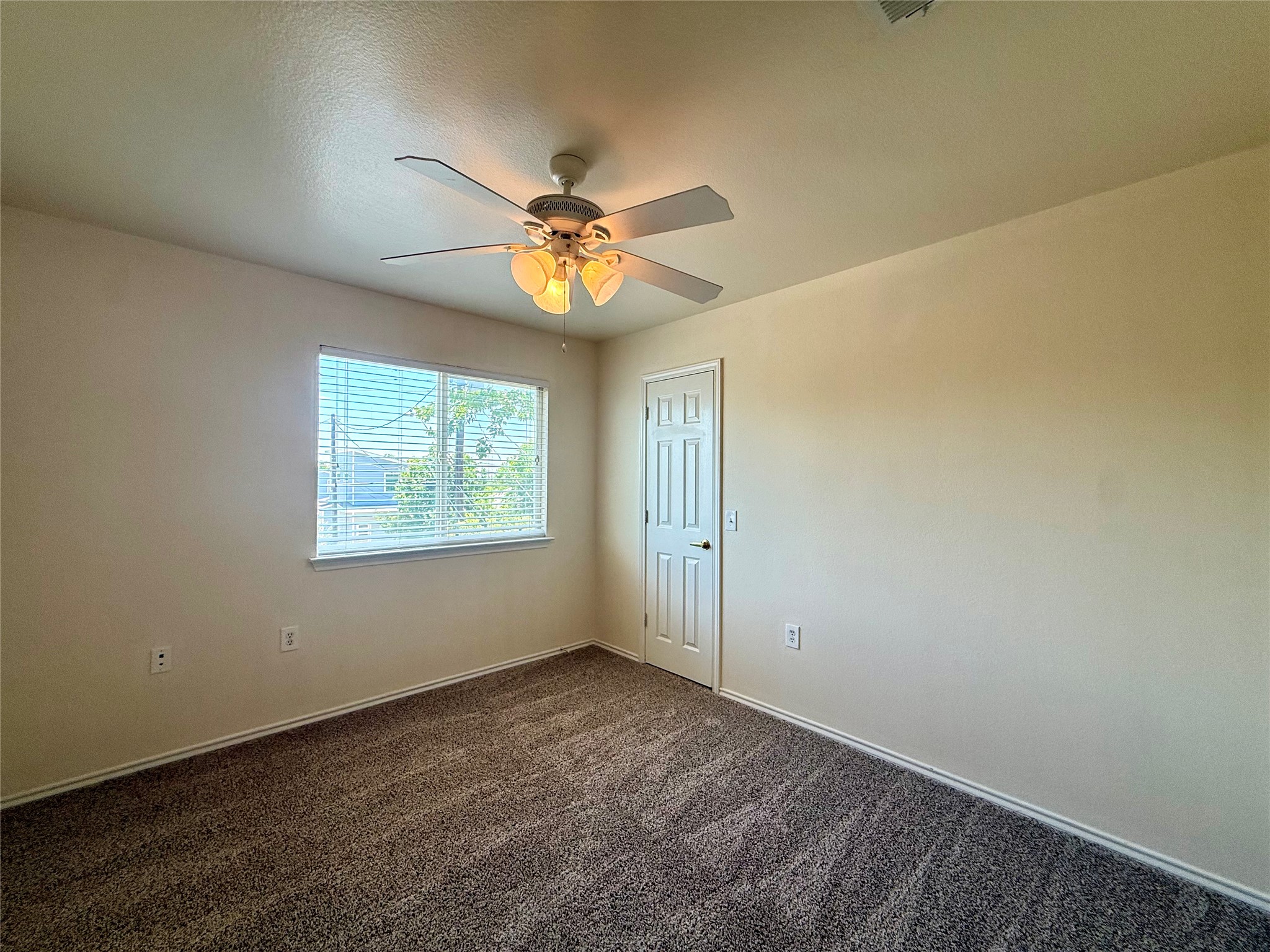 6912 Meador Avenue, Unit A Austin, TX 78752 - Photo 19 of 24 an empty room with windows and fan