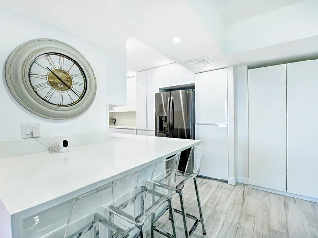 a kitchen with stainless steel appliances a refrigerator and a stove top oven