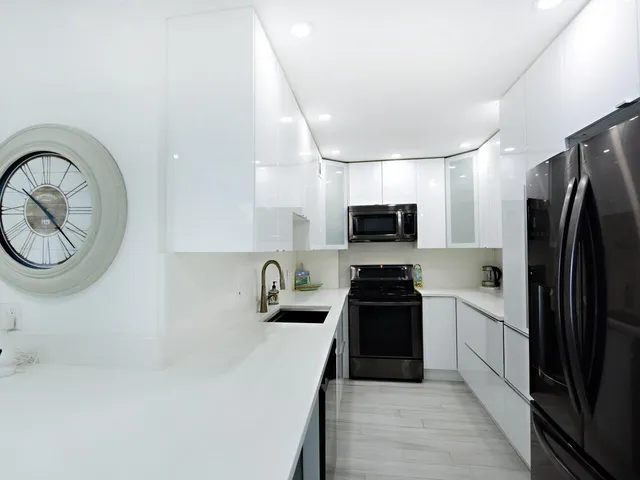 a kitchen with cabinets stainless steel appliances and a counter space