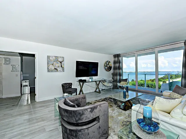 a living room with furniture and a floor to ceiling window