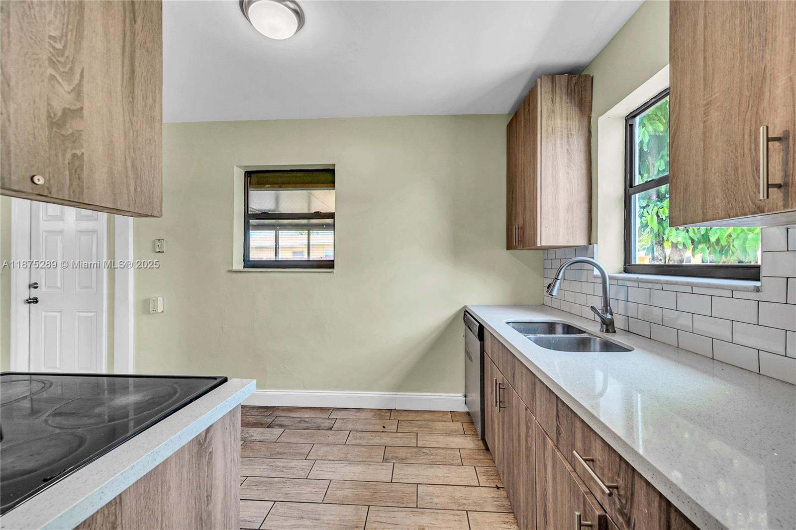 17130 Northeast 7th Avenue North Miami Beach, FL 33162 - Photo 11 of 38 a kitchen with a sink stove and cabinets