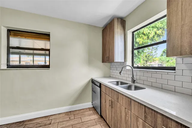 a kitchen with a sink and large window