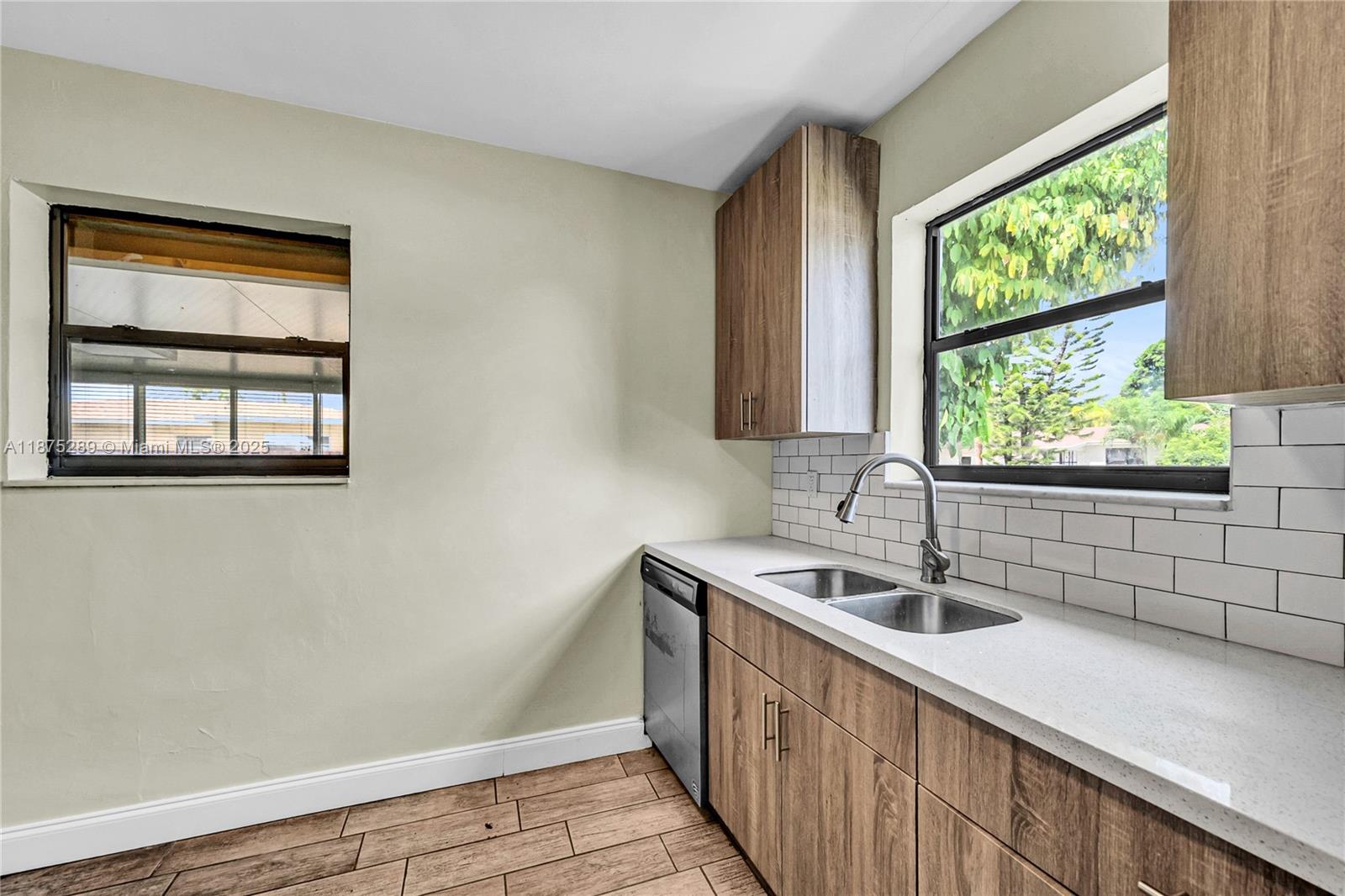 17130 Northeast 7th Avenue North Miami Beach, FL 33162 - Photo 12 of 38 a kitchen with a sink and large window