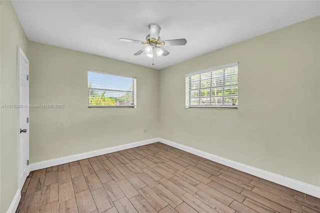 wooden floor in an empty room with a window