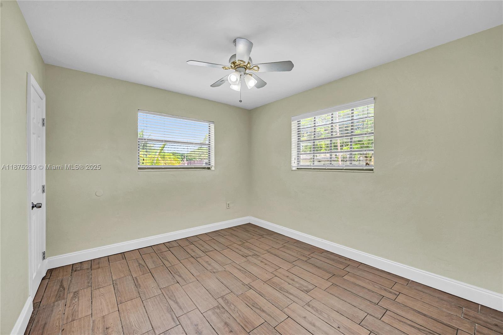 17130 Northeast 7th Avenue North Miami Beach, FL 33162 - Photo 14 of 38 wooden floor in an empty room with a window