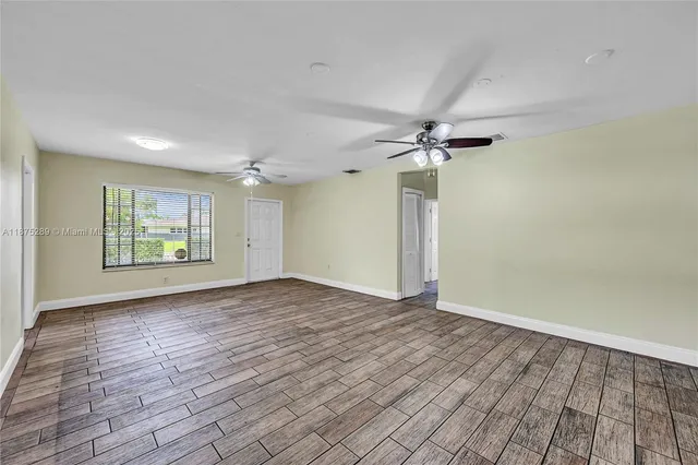 wooden floor in an empty room with a window