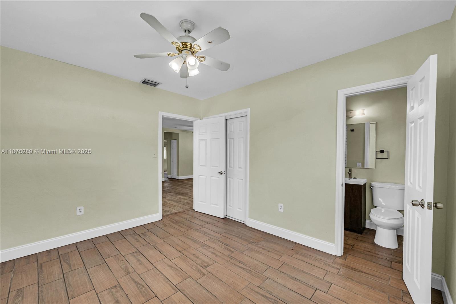 17130 Northeast 7th Avenue North Miami Beach, FL 33162 - Photo 16 of 38 wooden floor in an empty room with a bathroom