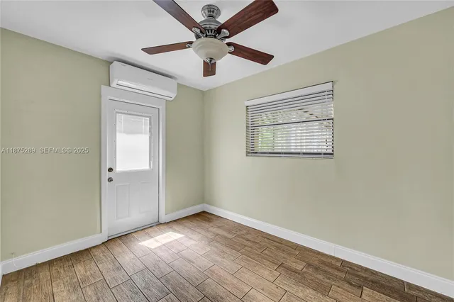 wooden floor in an empty room with a window