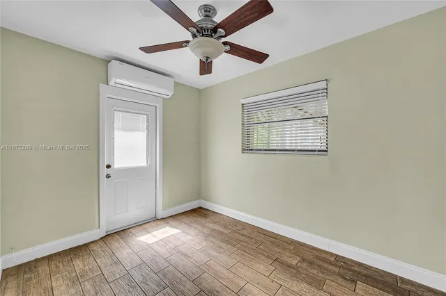 wooden floor in an empty room with a window
