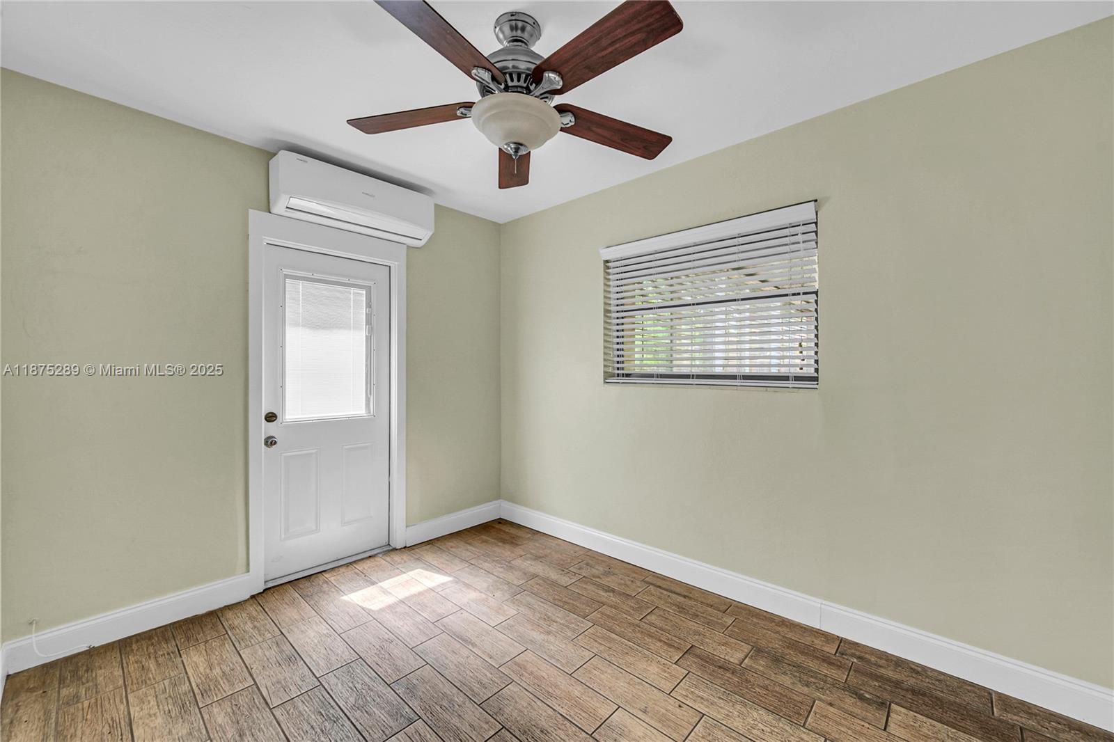 17130 Northeast 7th Avenue North Miami Beach, FL 33162 - Photo 17 of 38 wooden floor in an empty room with a window