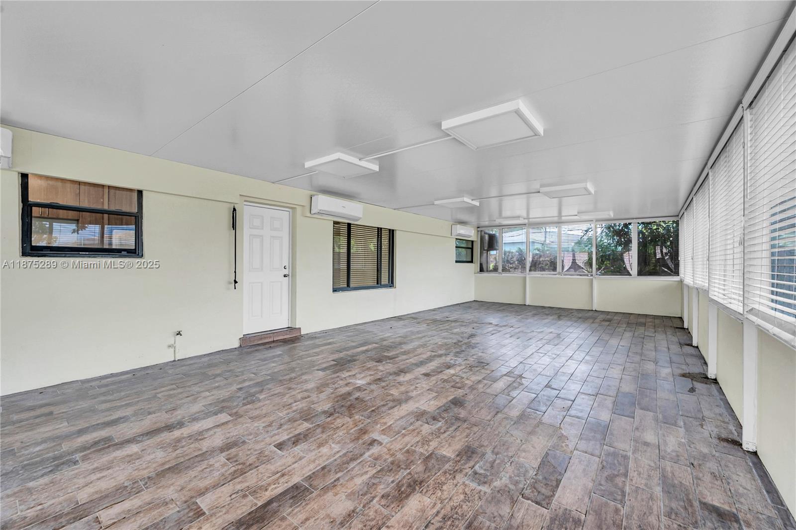 17130 Northeast 7th Avenue North Miami Beach, FL 33162 - Photo 22 of 38 a view of a big room with wooden floor and windows