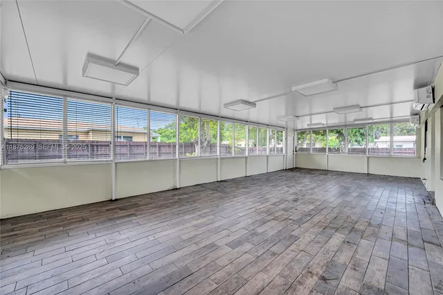 an empty room with wooden floor