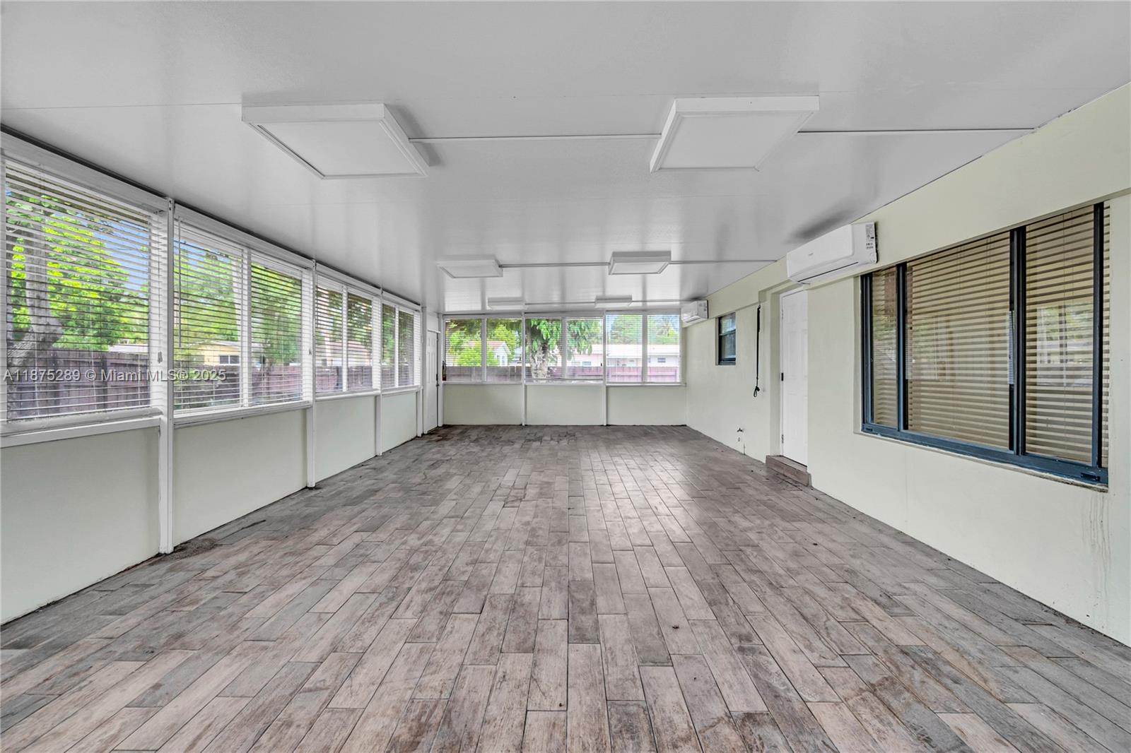 17130 Northeast 7th Avenue North Miami Beach, FL 33162 - Photo 25 of 38 an empty room with wooden floor and windows