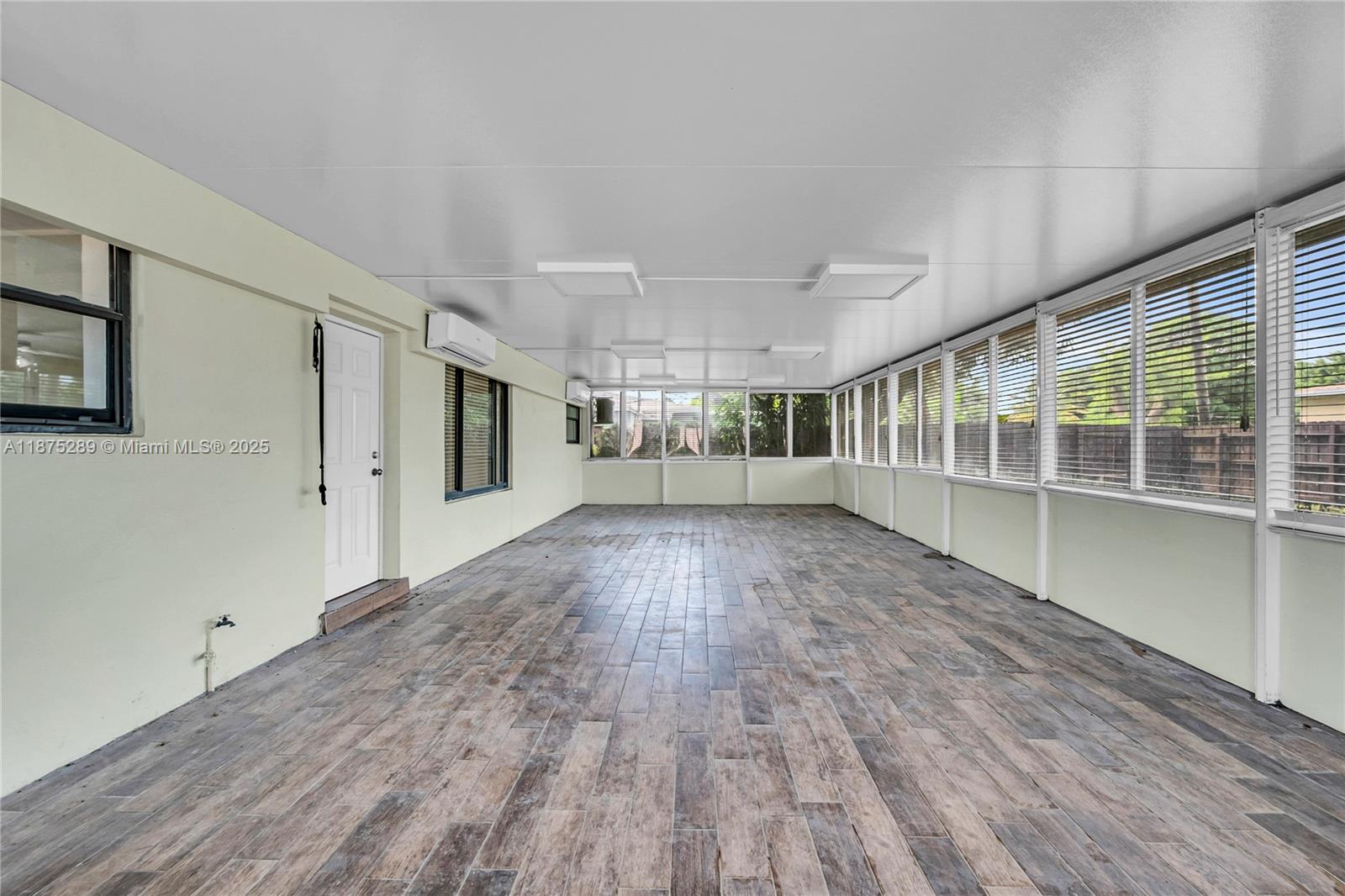 17130 Northeast 7th Avenue North Miami Beach, FL 33162 - Photo 26 of 38 a view of empty room with wooden floor and fan