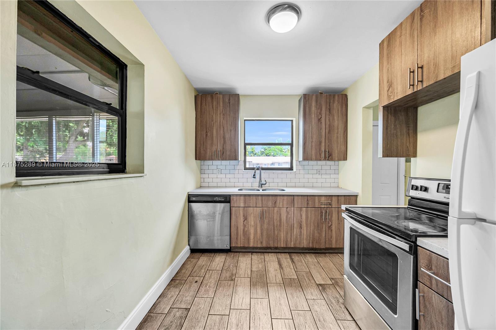 17130 Northeast 7th Avenue North Miami Beach, FL 33162 - Photo 6 of 38 a kitchen with stainless steel appliances granite countertop a stove a sink and a refrigerator