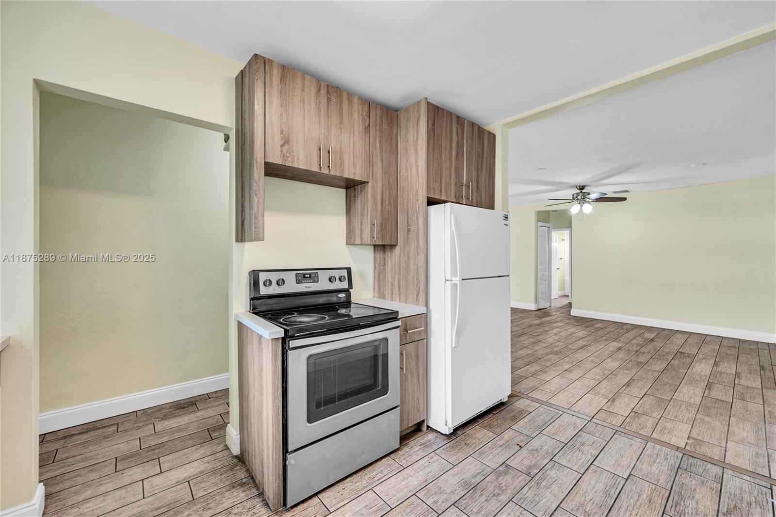 17130 Northeast 7th Avenue North Miami Beach, FL 33162 - Photo 8 of 38 a kitchen with a stove a refrigerator and a cabinets