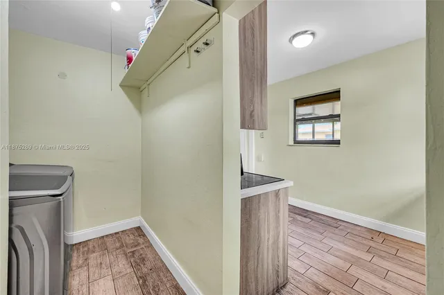 a view of hallway with wooden floor