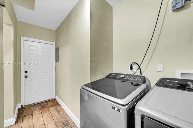 a utility room with sink dryer and washer