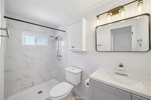 a bathroom with a sink a toilet and shower curtain