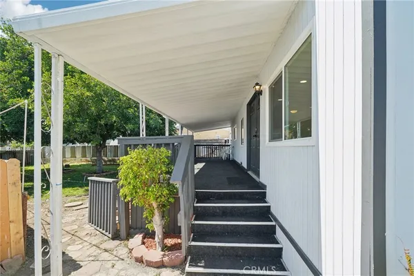 a view of a porch with wooden floor and outdoor seating