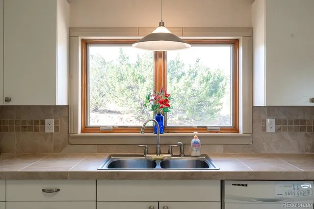 a kitchen with sink cabinets and window