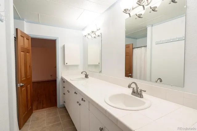a bathroom with a double vanity sink and a mirror