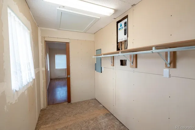 a view of a porch with furniture and a yard