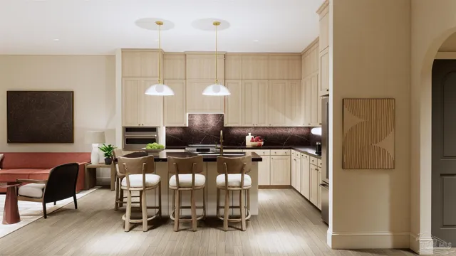 a kitchen with kitchen island granite countertop a stove a refrigerator a dining table and chairs with wooden floor