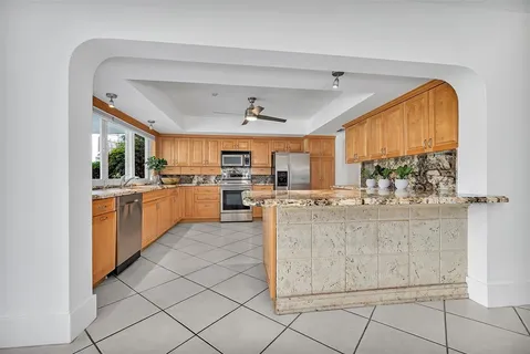 a kitchen with cabinets and chairs