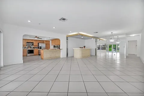 a view of a living room and kitchen with furniture