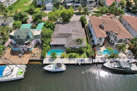 an aerial view of a house with swimming pool and outdoor space