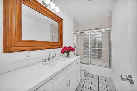 a bathroom with a sink vanity and a mirror