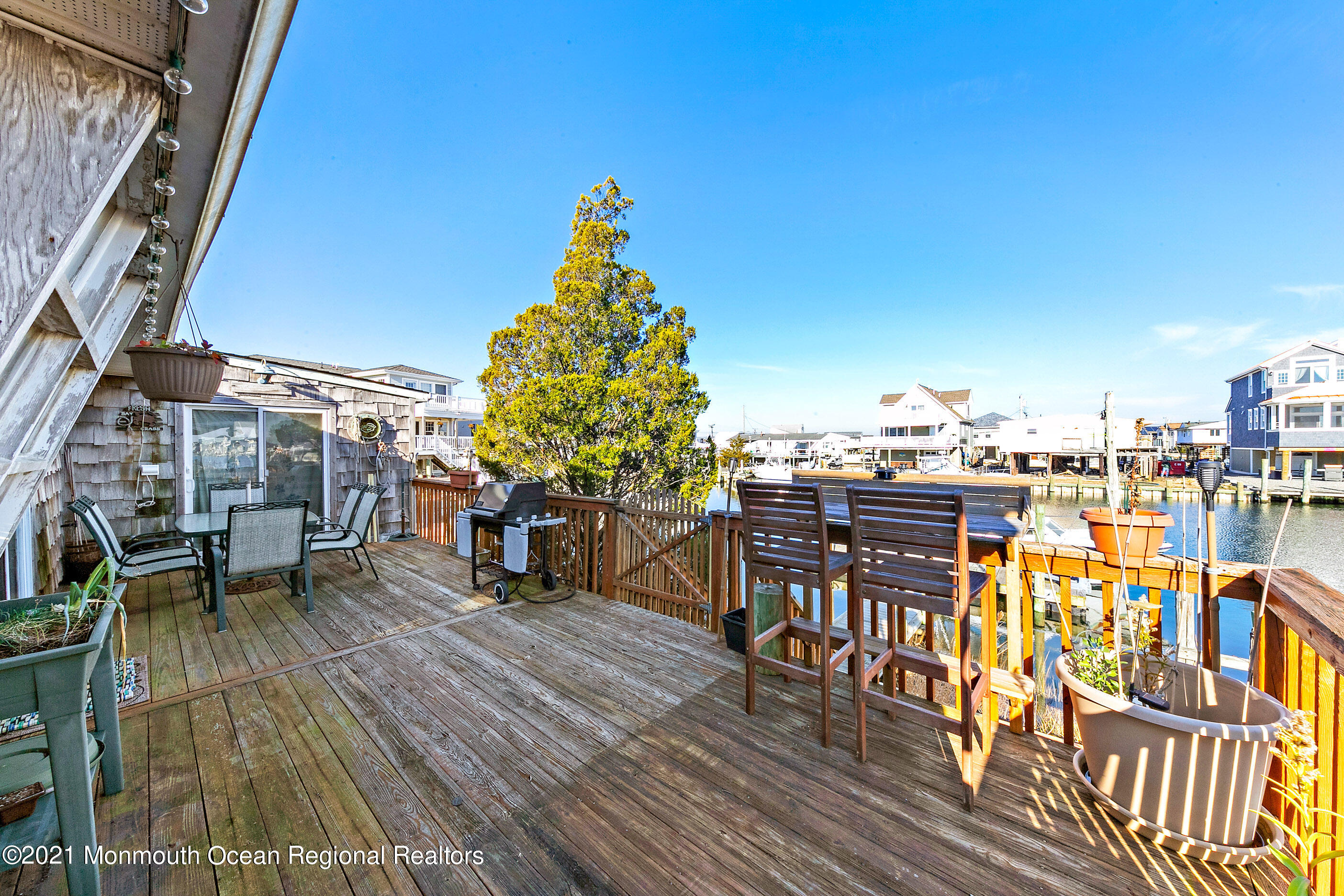 312 Heron Road Tuckerton, NJ 08087 - Photo 37 of 41 a view of a rooftop deck with chairs and wooden floor