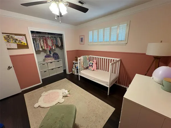 a bedroom with furniture and a wooden floor