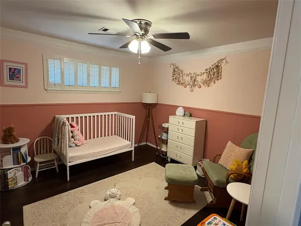 a bedroom with furniture and wooden floor