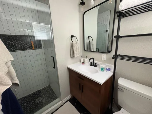 a bathroom with a sink toilet and shower