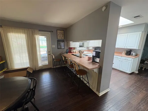 a open kitchen with stainless steel appliances granite countertop a stove and a refrigerator