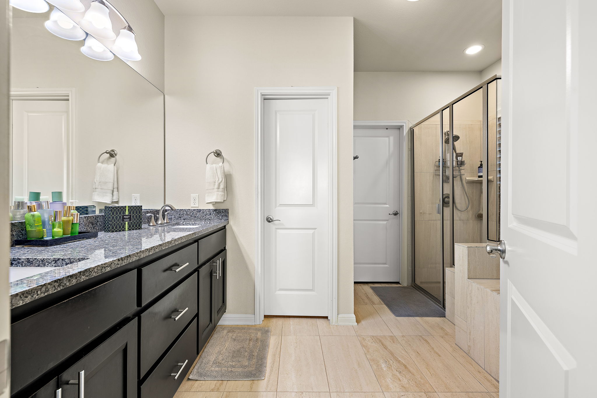 4413 Tambre Bend Austin, TX 78738 - Photo 13 of 30 a bathroom with a granite countertop sink a mirror and a shower