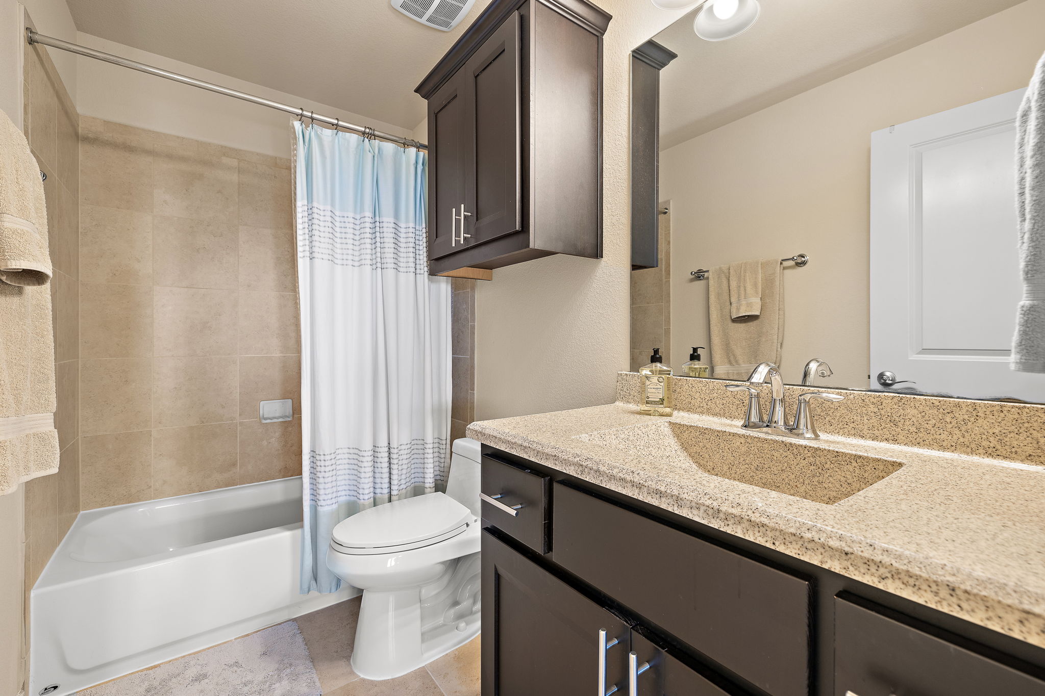 4413 Tambre Bend Austin, TX 78738 - Photo 21 of 30 a bathroom with a granite countertop sink toilet and shower